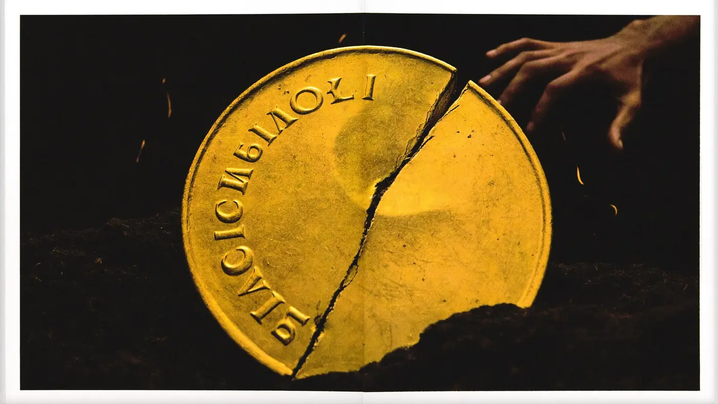 A cracked, dimmed gold coin with a hand reaching for it